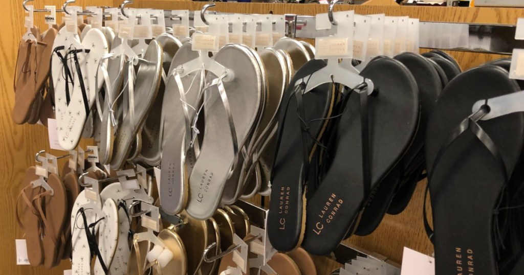 black and silver flip flops hanging in store