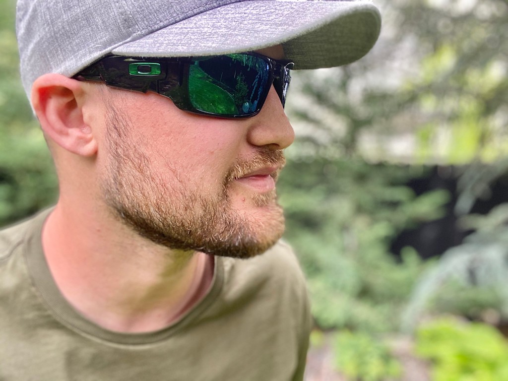 man wearing oakley sunglasses with hat