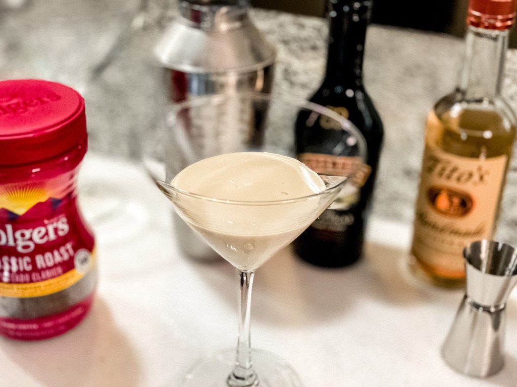 clear cocktail glass with milk and ingredients in background