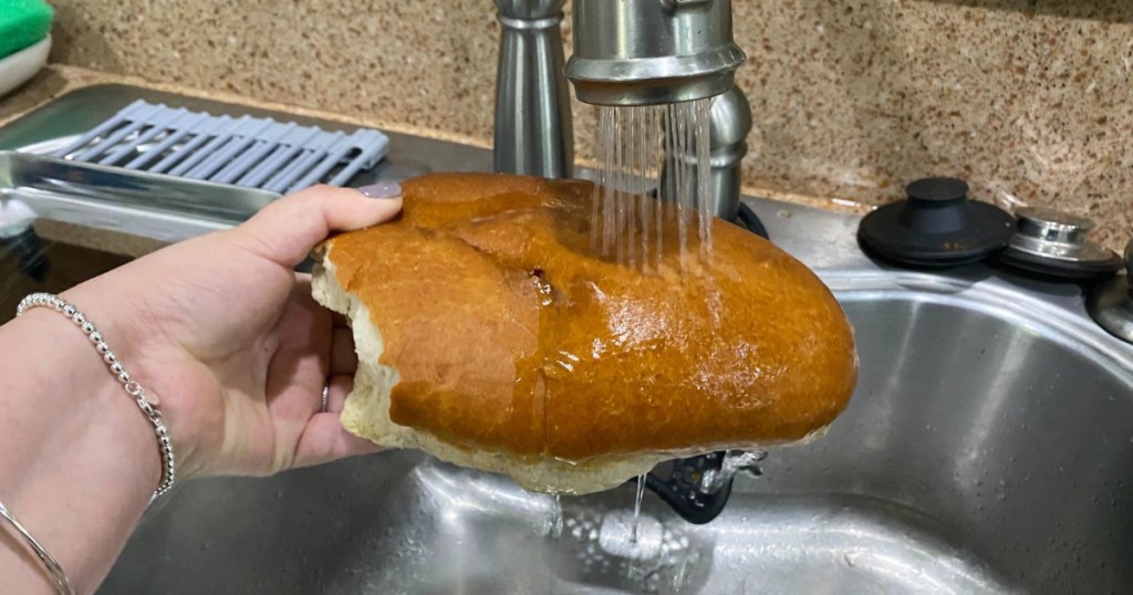 pouring water on bread in the sink