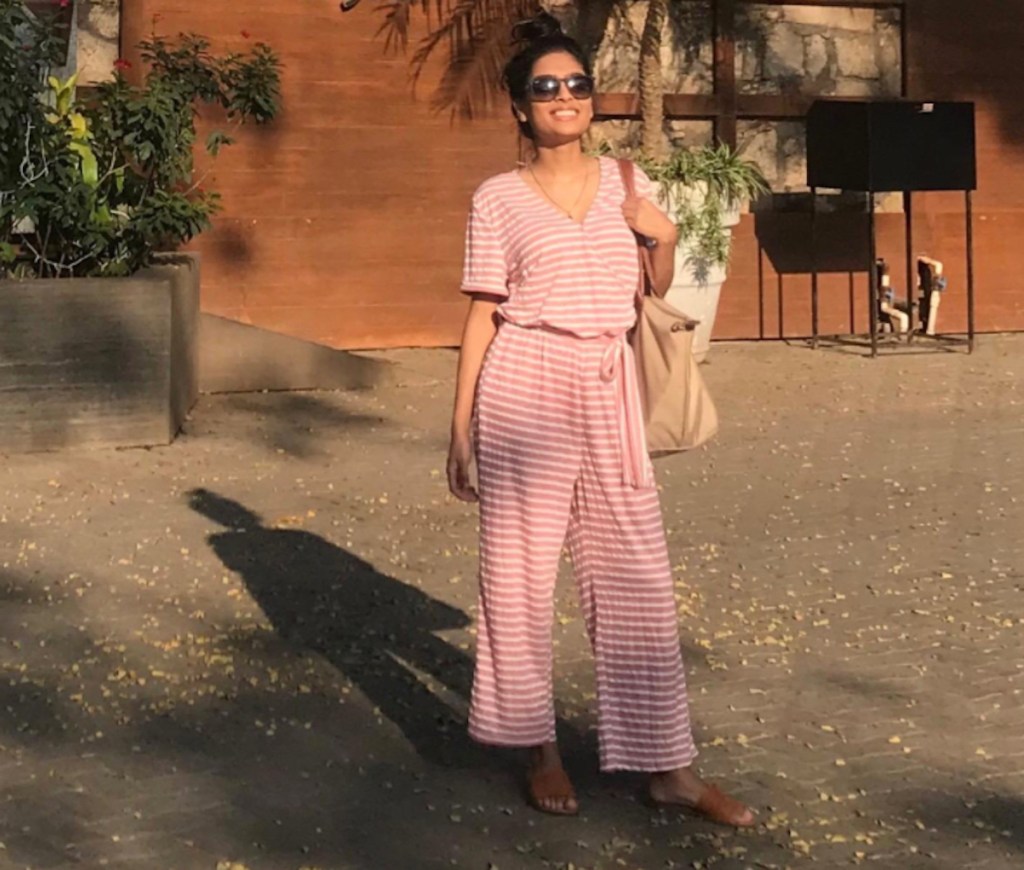 woman wearing red and white stripe belted romper outside