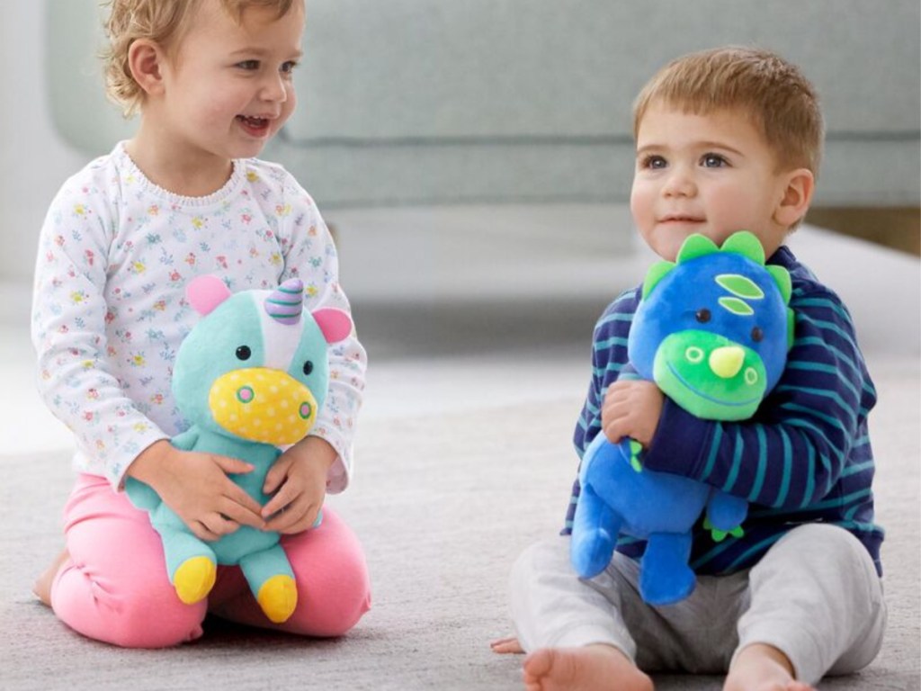 toddler girl and boy holding animal plushies