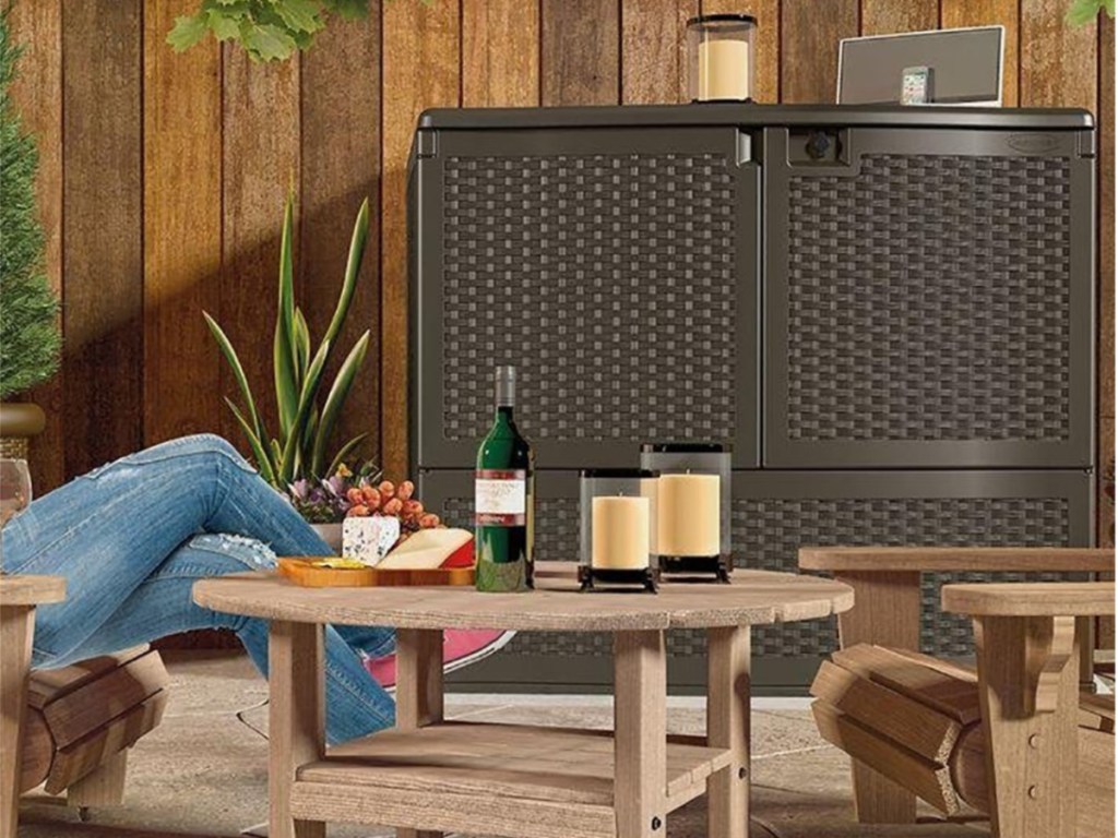deck box on patio with candle and speaker on top