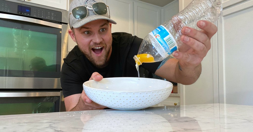 man looking at water bottle, bowl, and egg