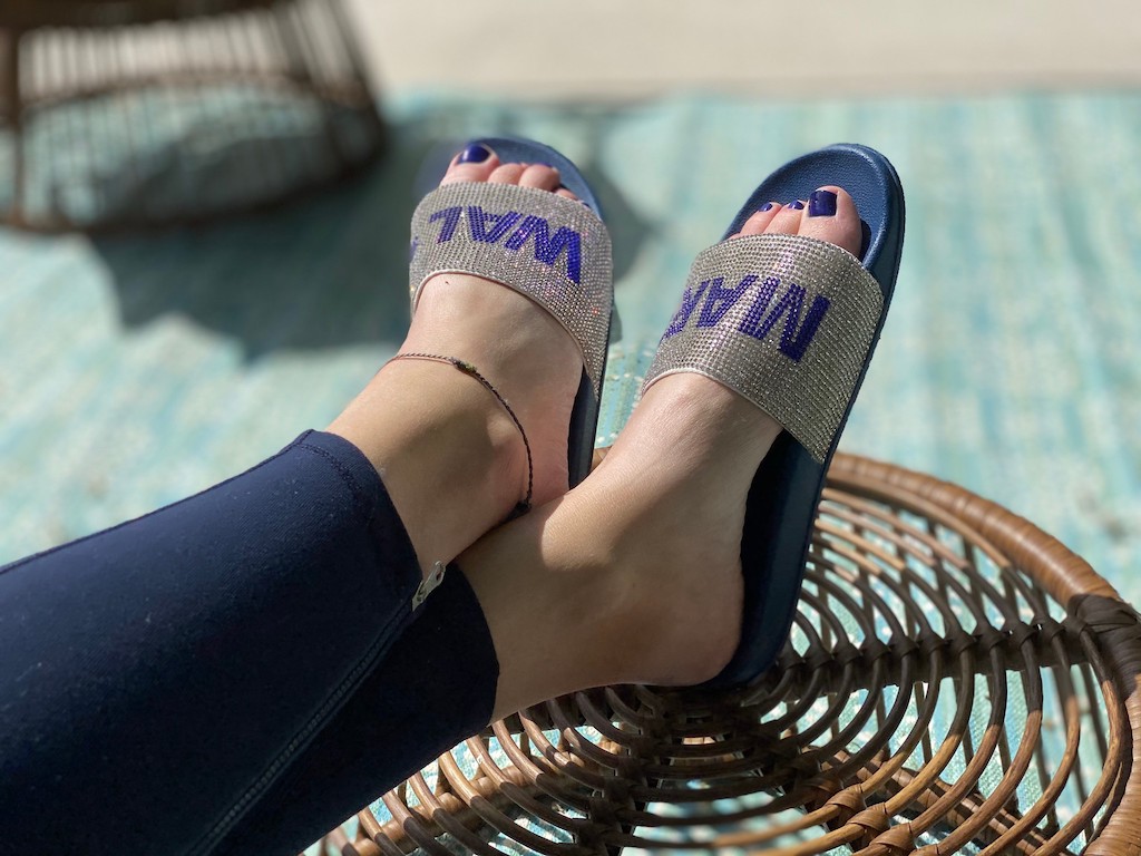 woman with blinged out Walmart slides on stool 