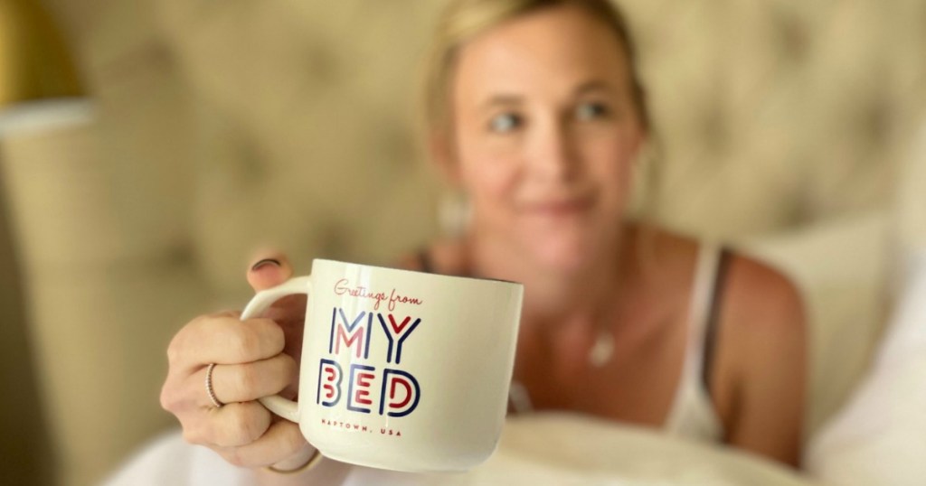 woman holding greetings from my bed mug 