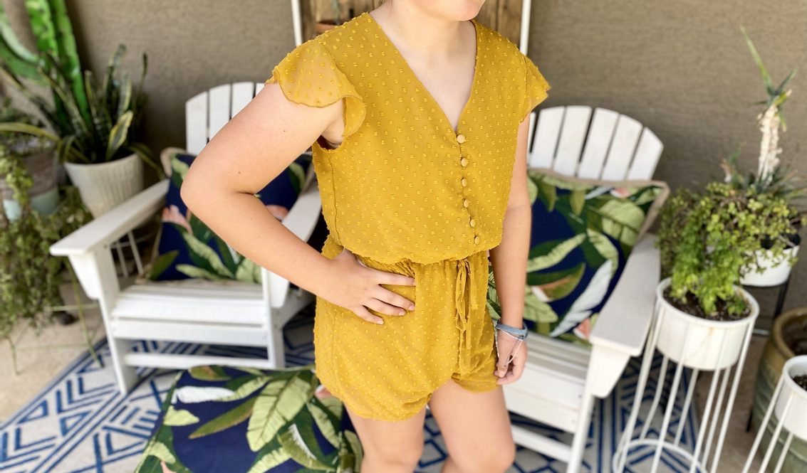 girl wearing yellow romper