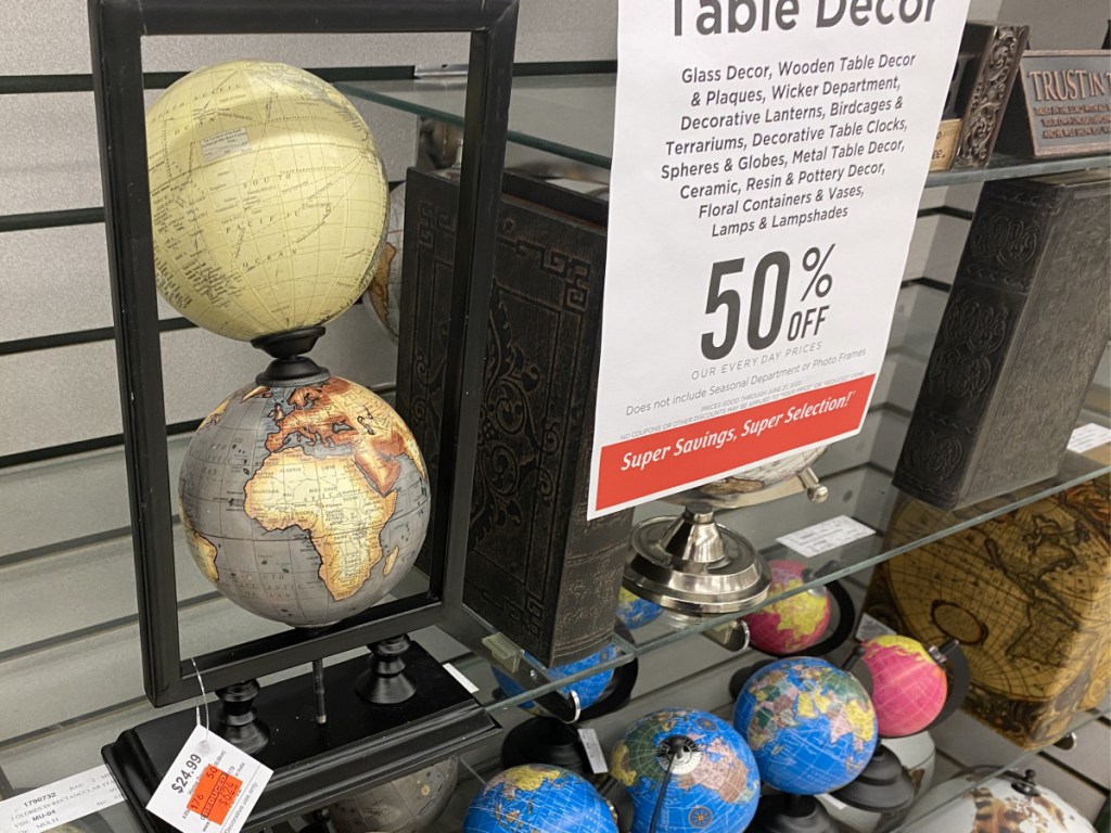 decorative stand with two globes on store shelf
