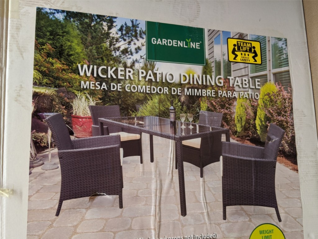 large outdoor patio table surrounded by brown wicker chairs