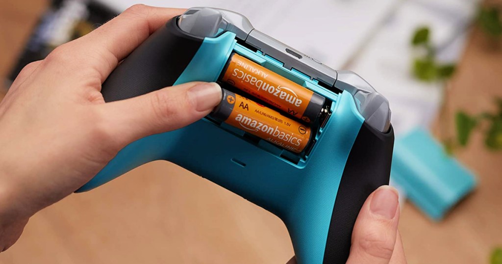AmazonBasics AA Rechargeable Batteries being put in game controller