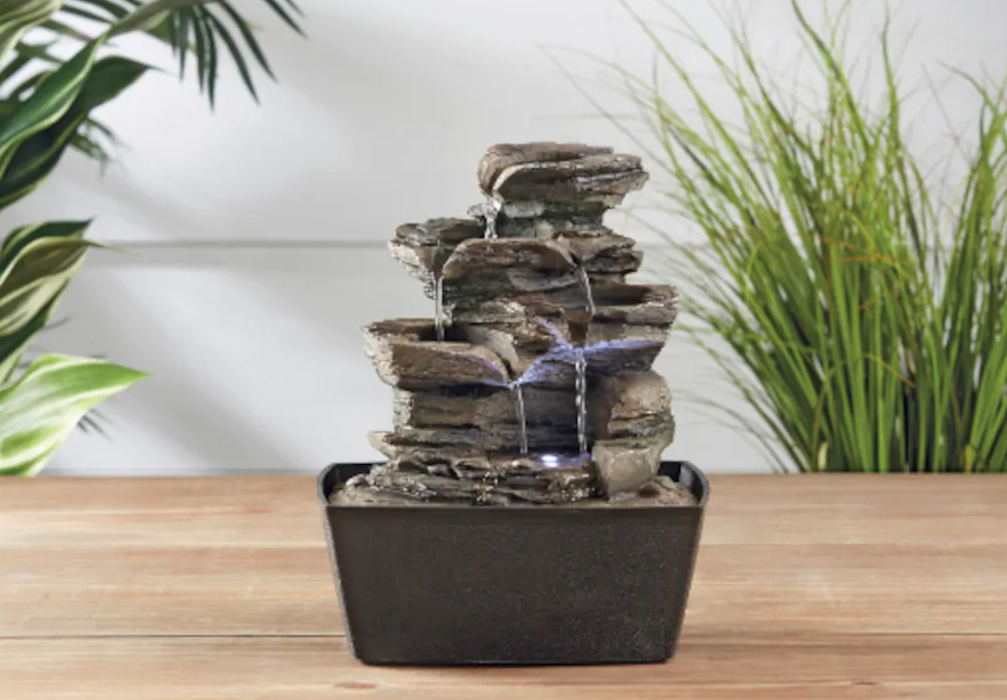 small stone water fountain on a table