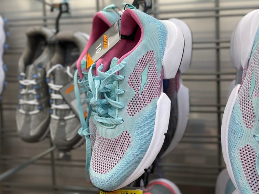 light blue and pink sneakers hanging in store