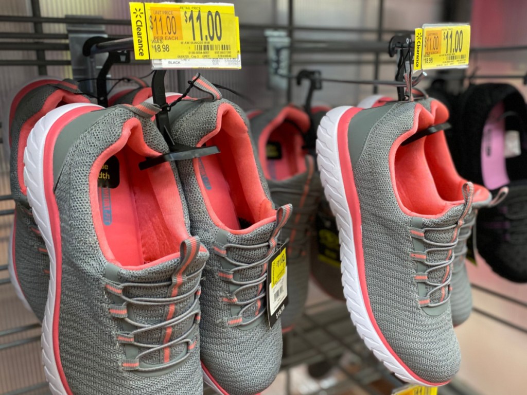 women's gray and pink sneakers hanging in store