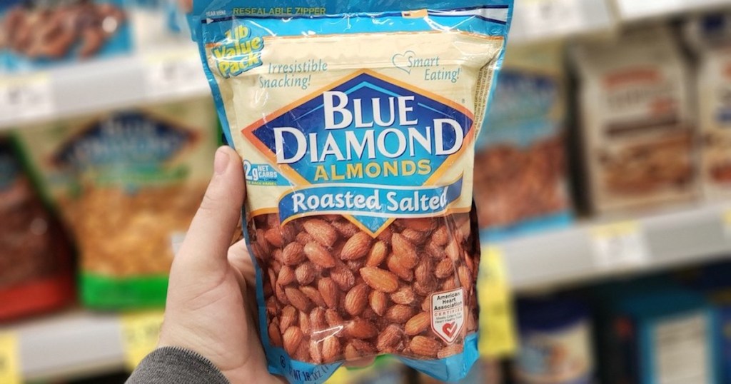 man hand holding blue bag of Blue Diamond Almonds Roasted Salted