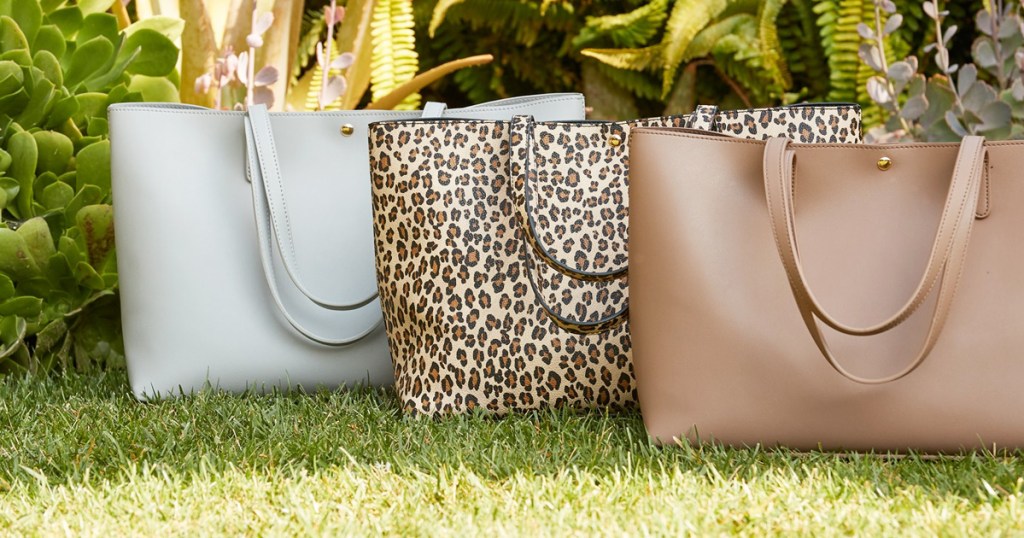 white, leopard print, and brown tote bags sitting on grass