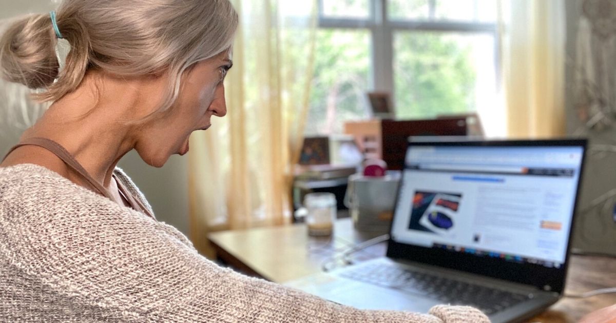 Woman looking surprised at deals in the Amazon Outlet on a computer