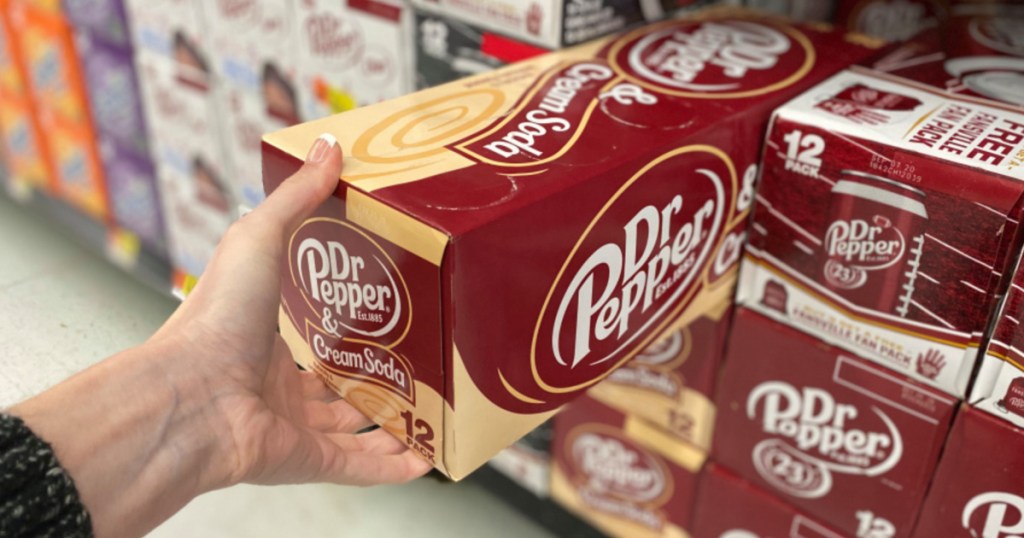 hand holding a Dr. Pepper & Cream Soda 12 pack 