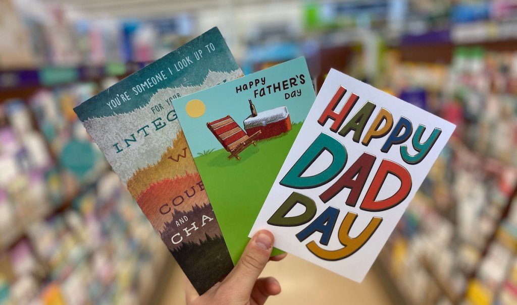 hand holding three Father's Day cards