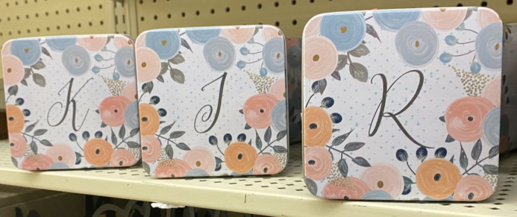 three floral metal monogram boxes on store shelf