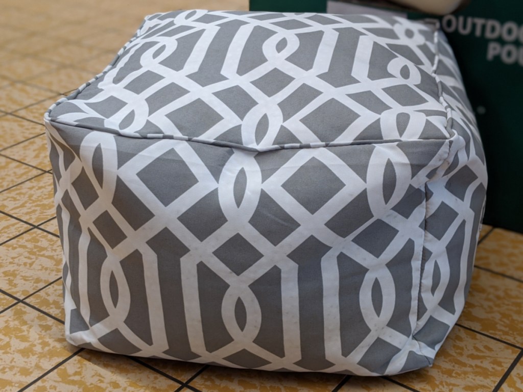 outdoor pouf with grey and white design on floor in store