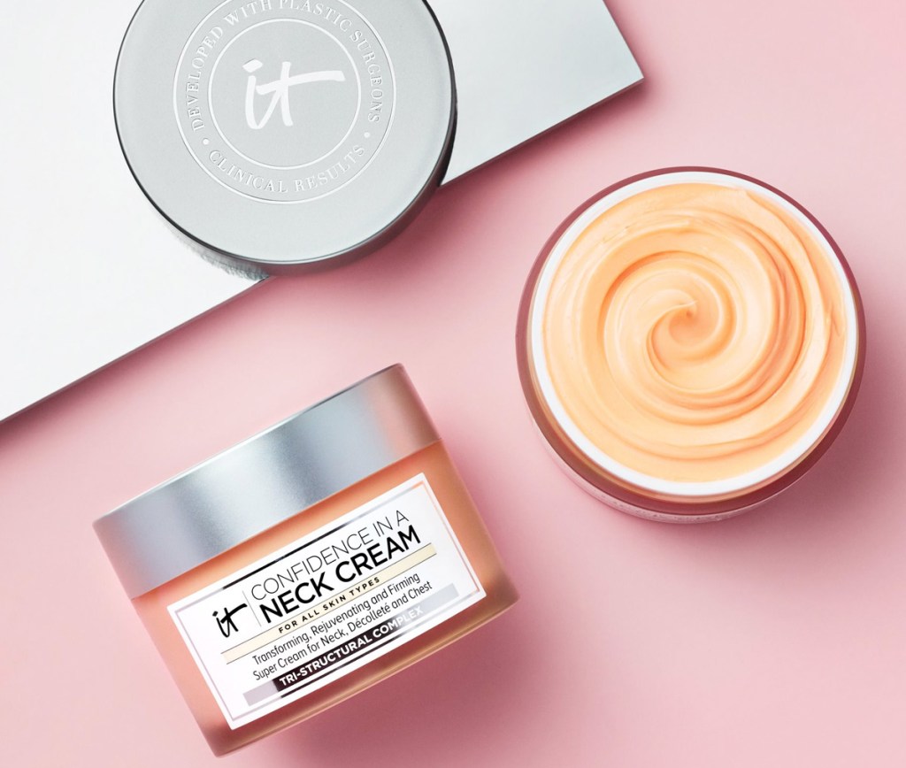 container and open container of orange tinted neck cream on a pink background
