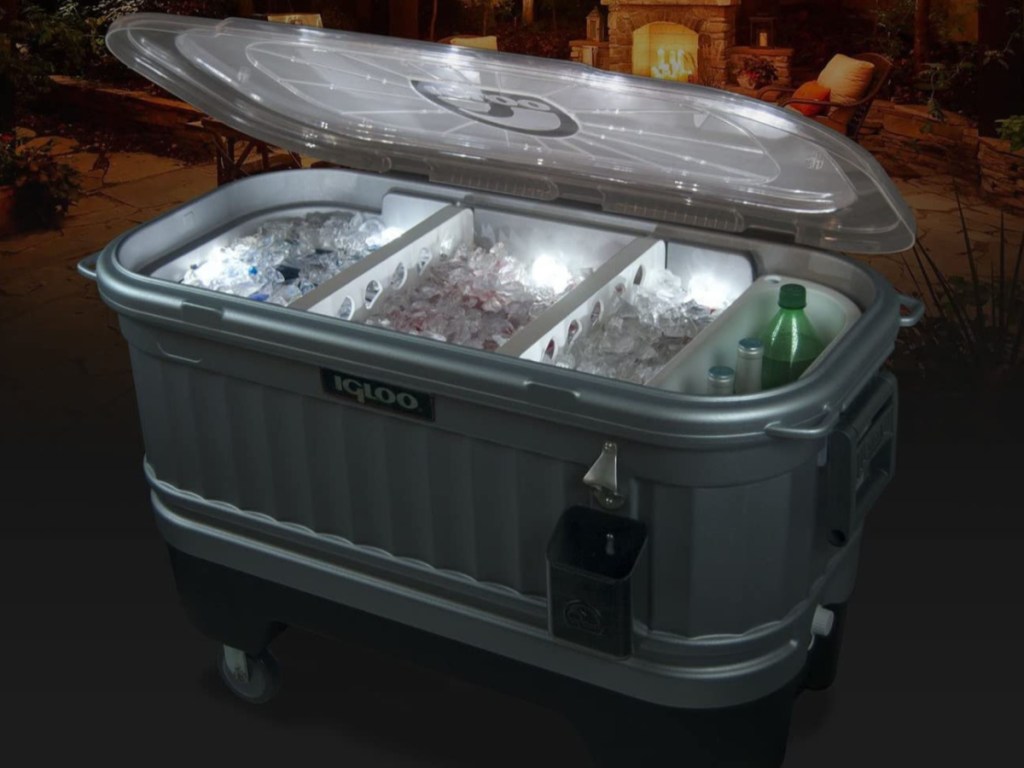 Igloo Cooler Bar Cooler on wheels lit up in the dark with drinks inside