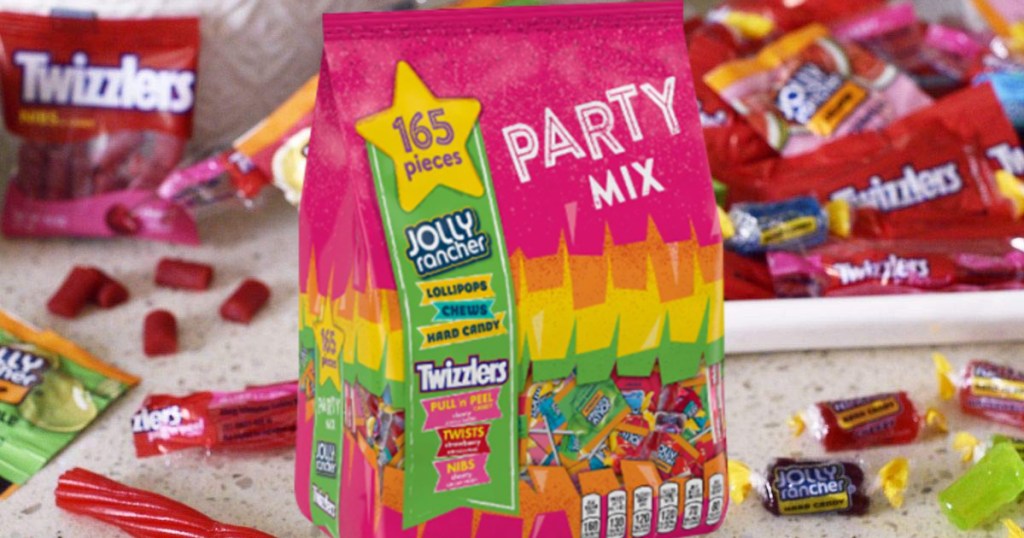 various fun size candies on table and on plate, and large bag of candy