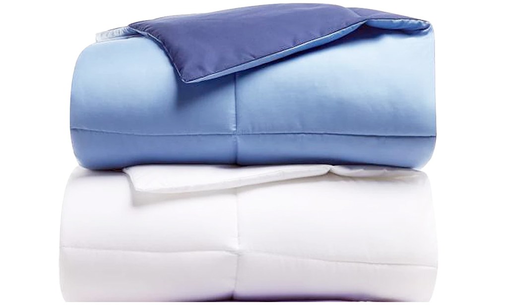 white and blue comforter sets folded and stacked on one another