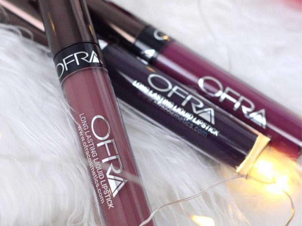 three purple and pink colored lipsticks