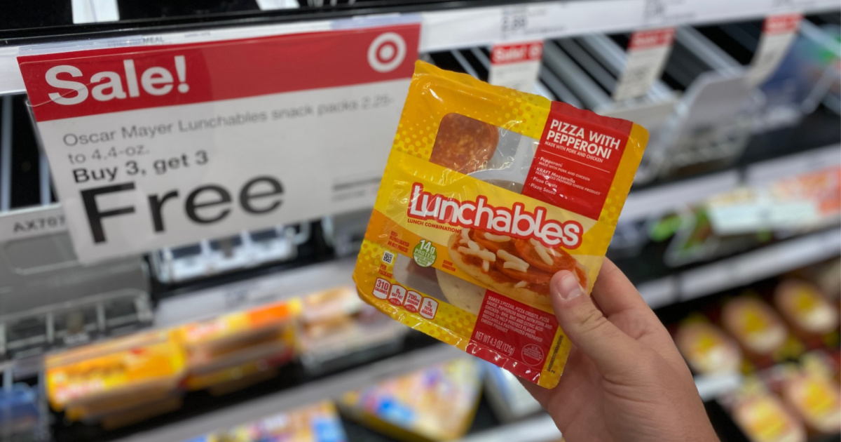 hand holding Lunchables up to sale sign in store