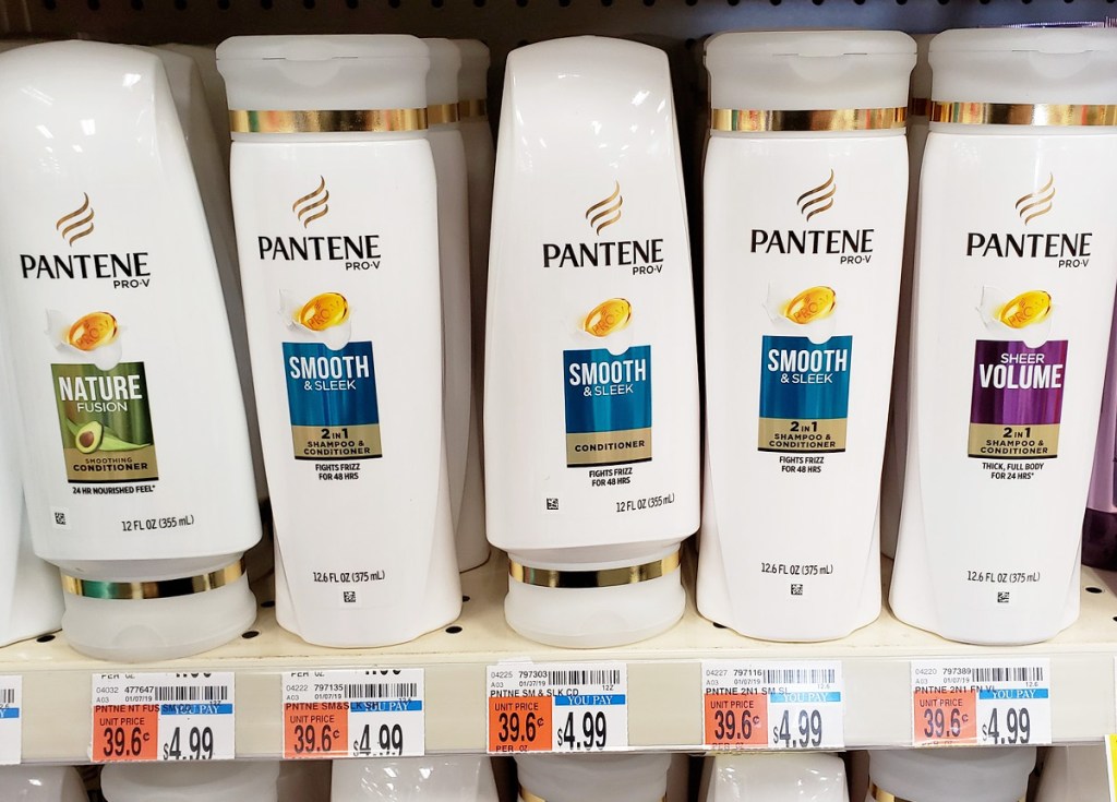 white bottles of pantene brand shampoo and conditioner on store shelf