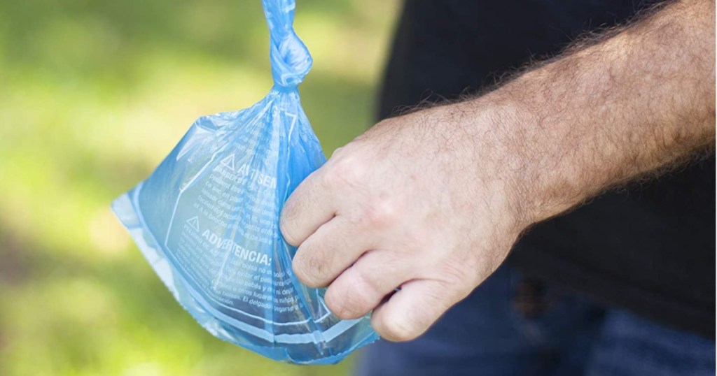 hand carrying blue disposable bag