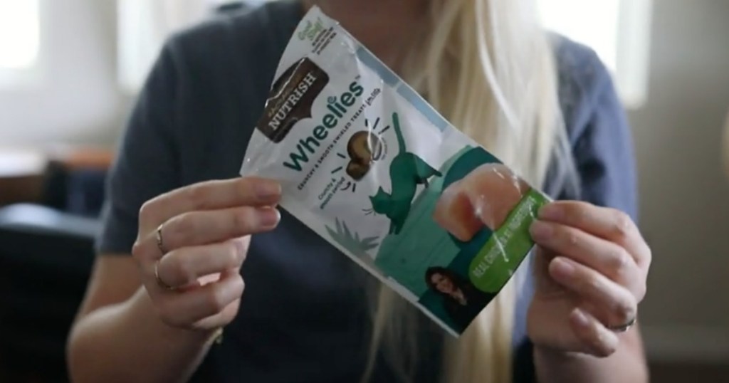 woman holding bag of cat treats