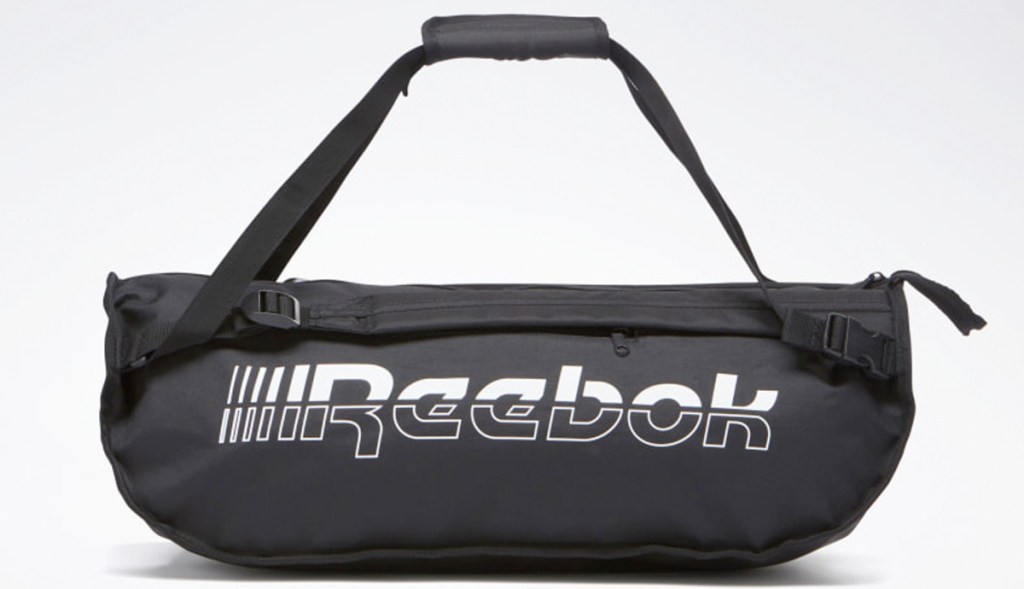 black duffel bag with white text that says reebok on the side