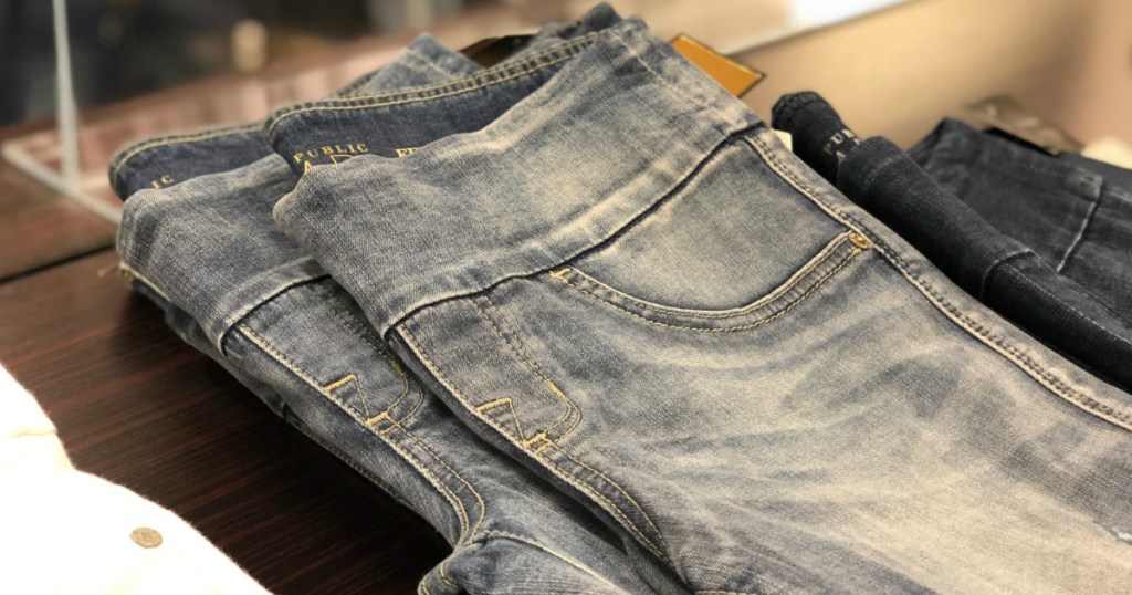 Women's faded denim jeans, folded on shelf in-store