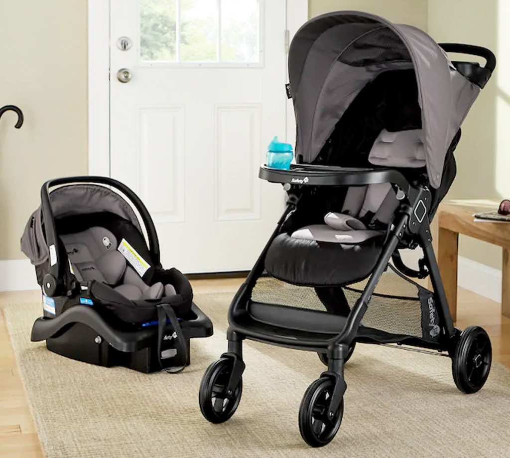 matching black and grey baby stroller and car seat on living room floor