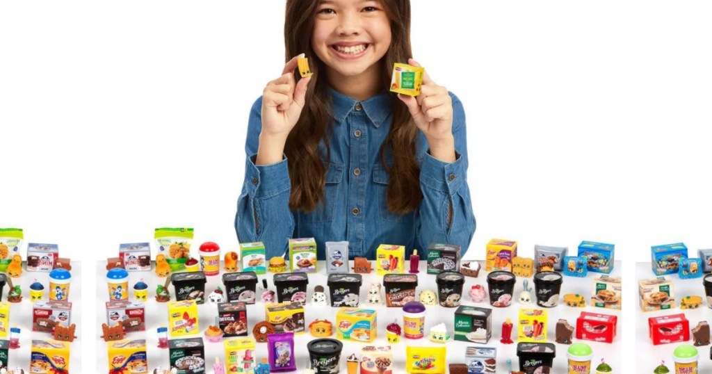 Girl holding up Shopkins Real Littles