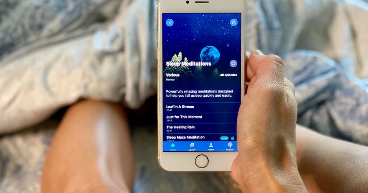 Person in bed with the Slumber sleep app open on a phone