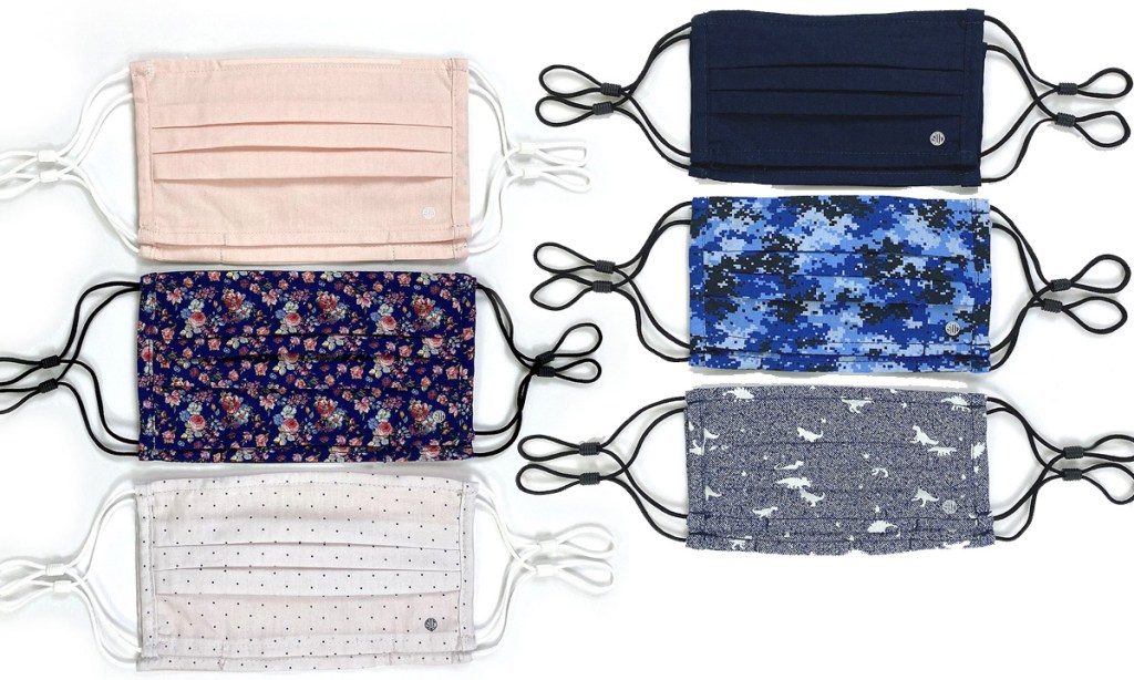 two sets of face masks with elastic ear loops in floral prints, solid color light pink, black, blue camo, and black dinosaur print