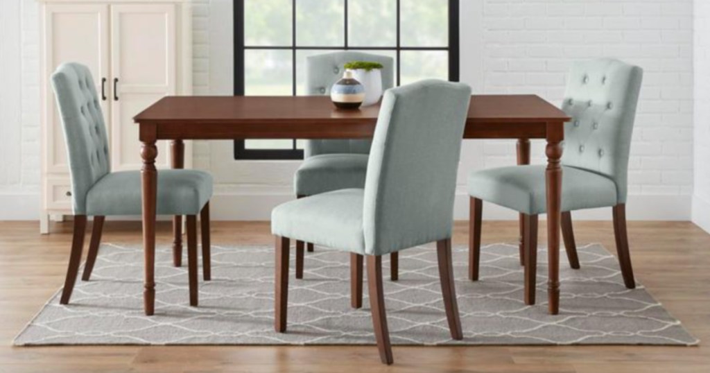 light blue tufted dining room chairs sitting around a brown kitchen table