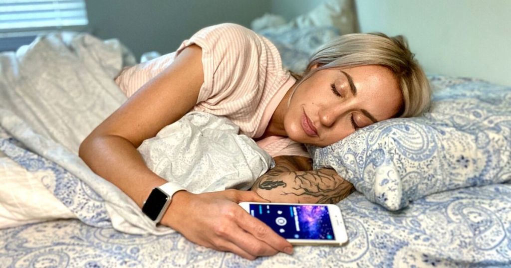 Woman falling asleep peacefully while listening to a sleep meditation