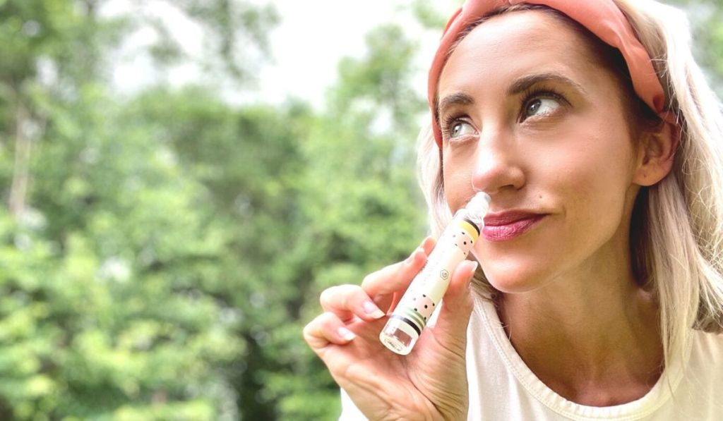 A woman smelling perfume