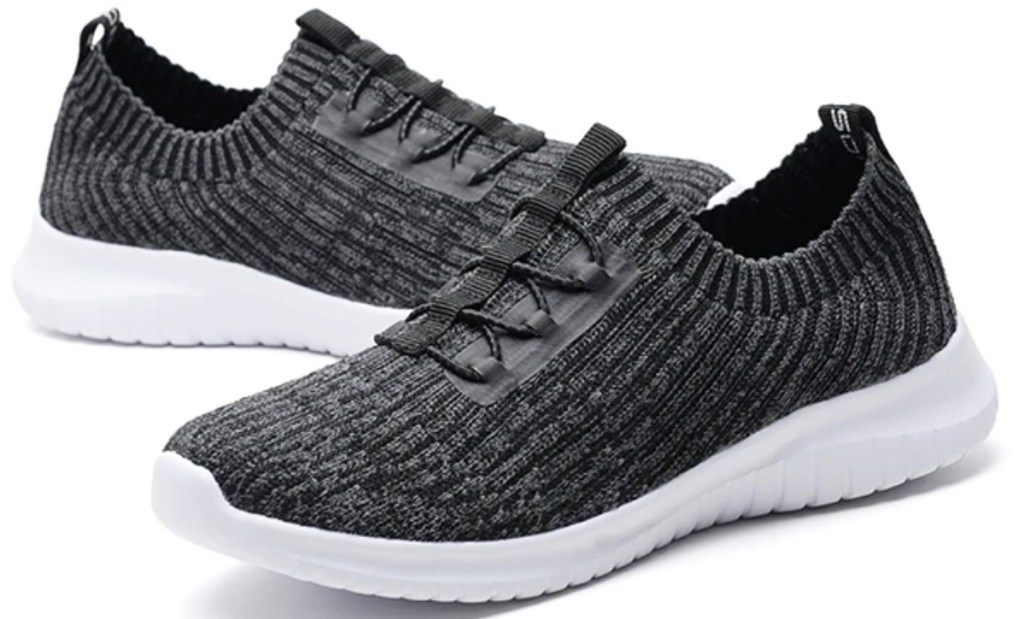 black pair of knit shoes with elastic ties and white soles