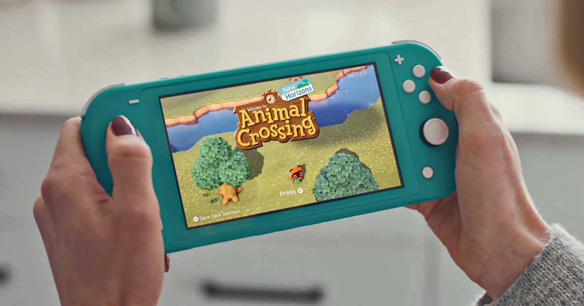 hands holding a nintendo switch console playing animal crossing