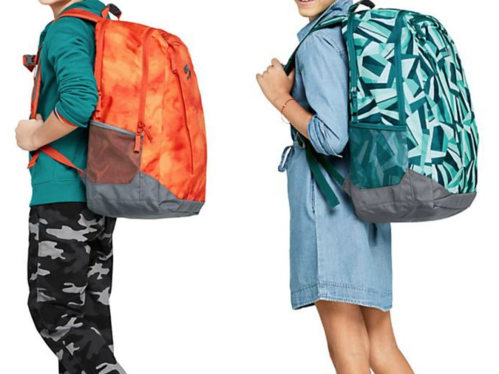 2 kids with colorful backpacks on