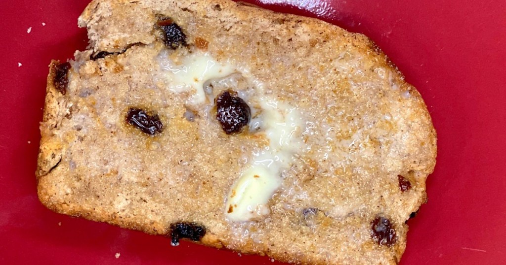 raisin cinnamon bread slice with butter slathered on top 