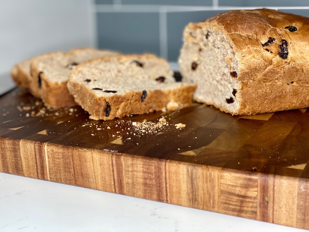 sliced cinnamon raisin bread on cutting board