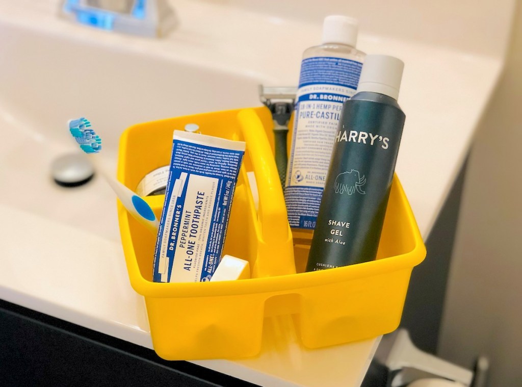 yellow classroom caddy on bathroom sink with bathroom essentials for getting ready