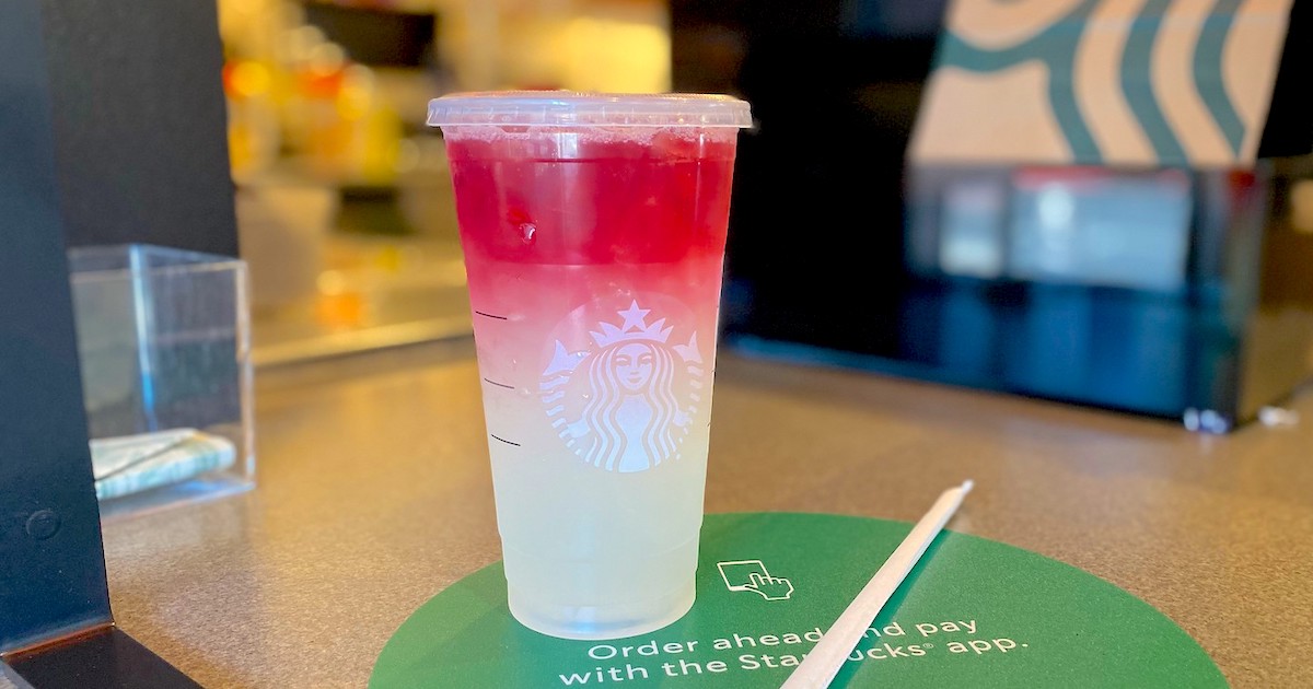 ombre red and white starbucks firecracker drink sitting on counter