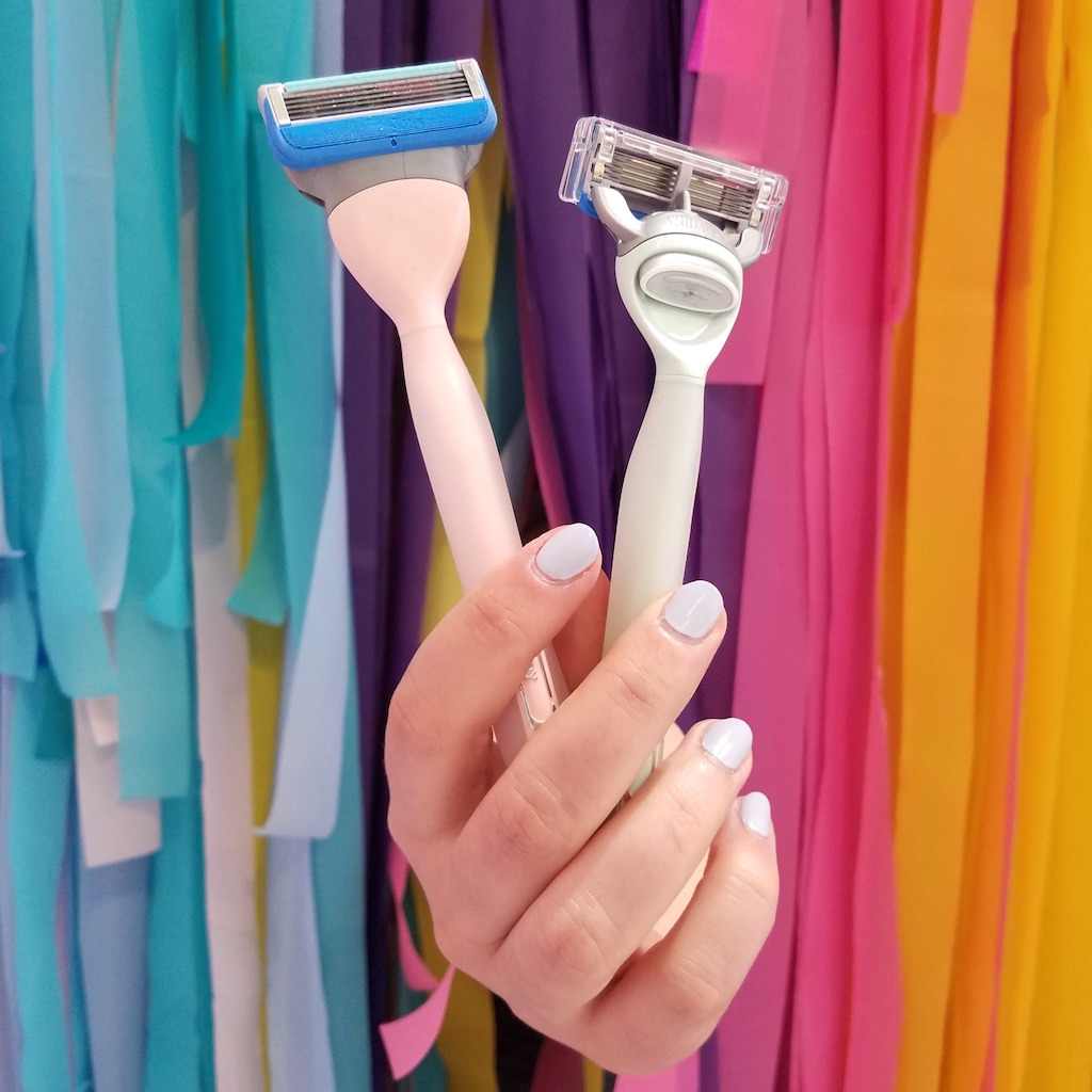 holding toy joy razors with colorful streamers in background